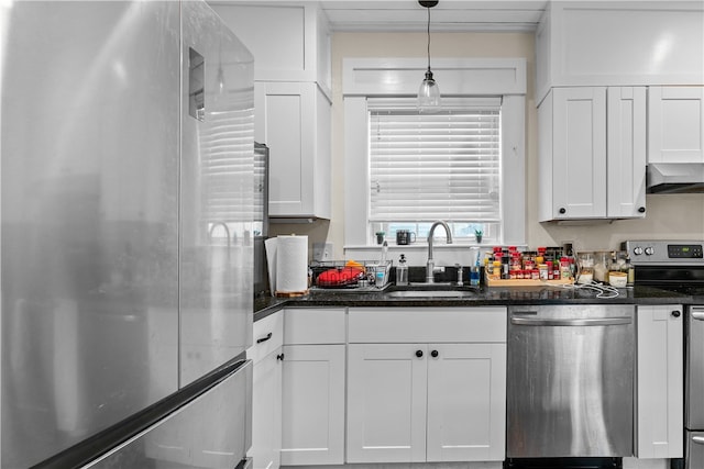 kitchen with ventilation hood, sink, white cabinetry, and stainless steel appliances