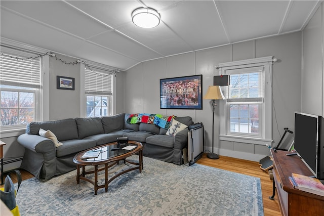 living room with hardwood / wood-style floors and radiator heating unit