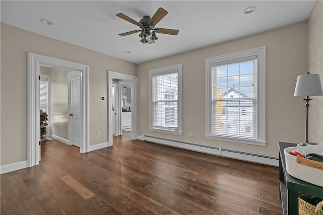 unfurnished bedroom with ceiling fan, dark hardwood / wood-style flooring, and baseboard heating