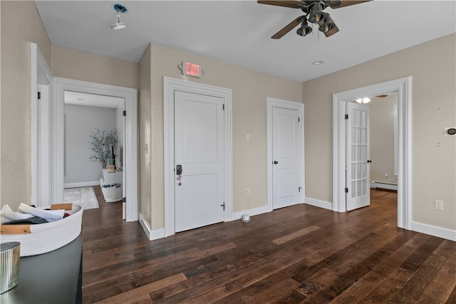 unfurnished bedroom featuring dark hardwood / wood-style floors, ceiling fan, and a baseboard heating unit