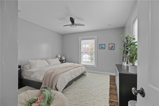 bedroom with ceiling fan and dark wood-type flooring