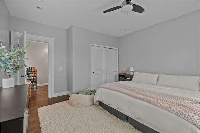 bedroom featuring a closet, dark hardwood / wood-style floors, and ceiling fan