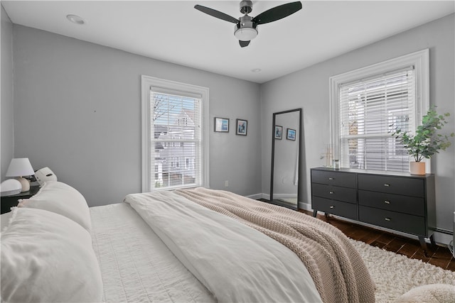 bedroom with ceiling fan and dark hardwood / wood-style flooring