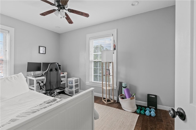 bedroom with ceiling fan and dark wood-type flooring