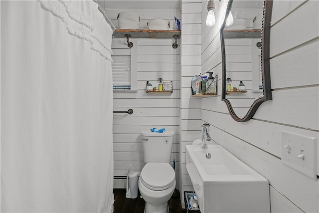 bathroom with wooden walls, hardwood / wood-style flooring, and toilet