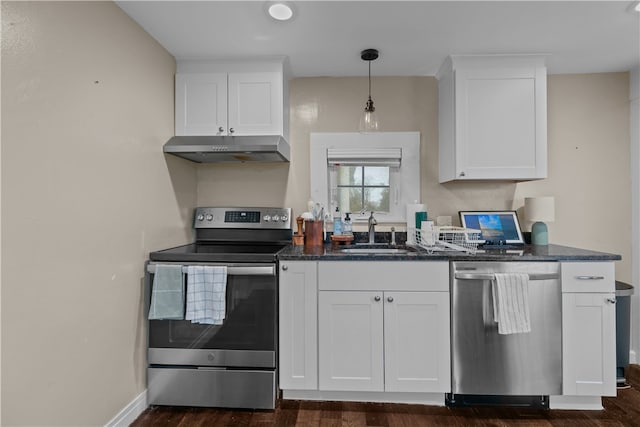 kitchen with appliances with stainless steel finishes, sink, decorative light fixtures, white cabinets, and dark hardwood / wood-style floors