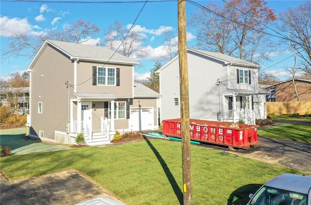 rear view of house with a yard and a garage