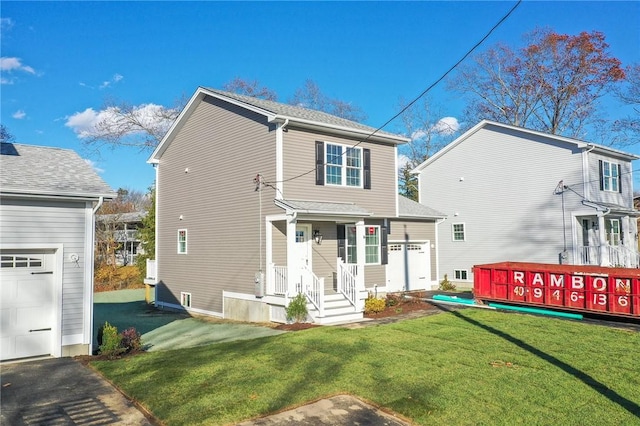 back of property featuring a yard and a garage