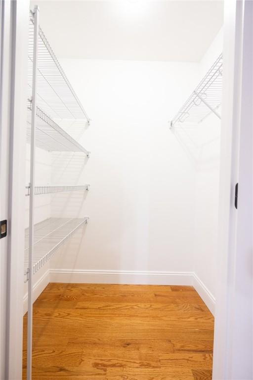 spacious closet featuring hardwood / wood-style flooring