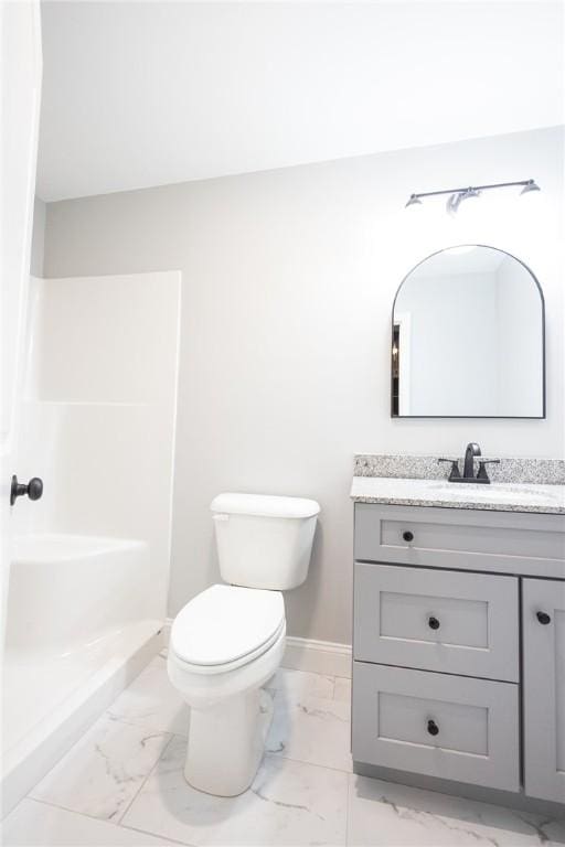 bathroom featuring a shower, vanity, and toilet