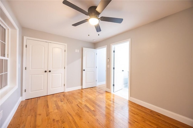 unfurnished bedroom with ceiling fan, light hardwood / wood-style floors, and a closet