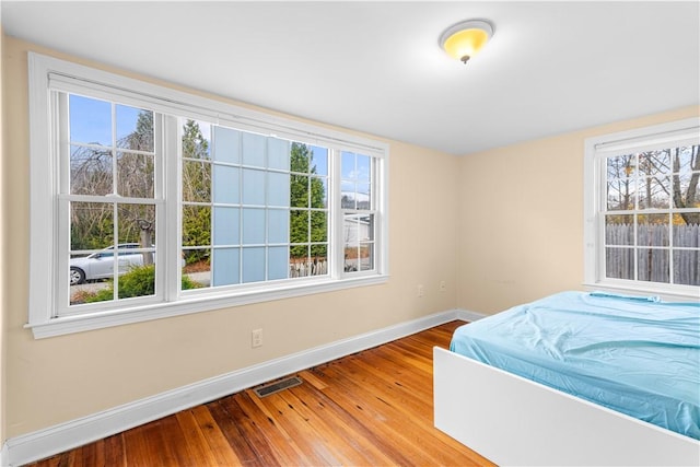 unfurnished bedroom with hardwood / wood-style floors