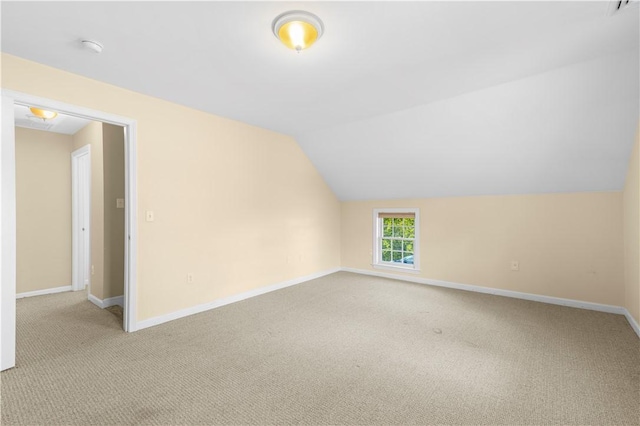 bonus room with light carpet and lofted ceiling