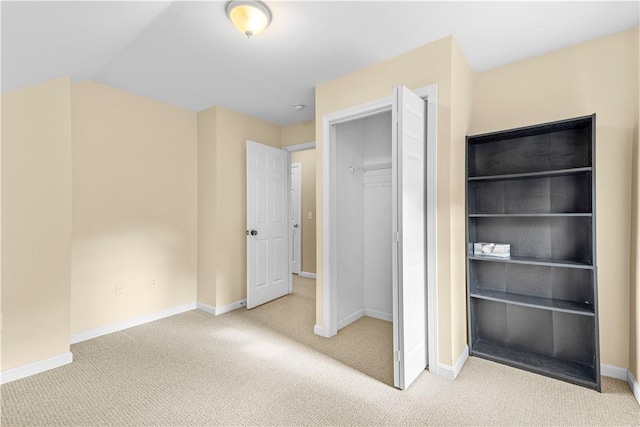 unfurnished bedroom featuring carpet and a closet