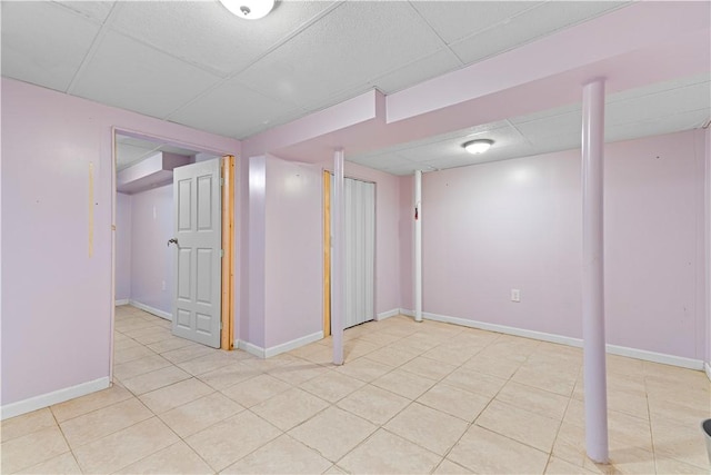 basement with a paneled ceiling