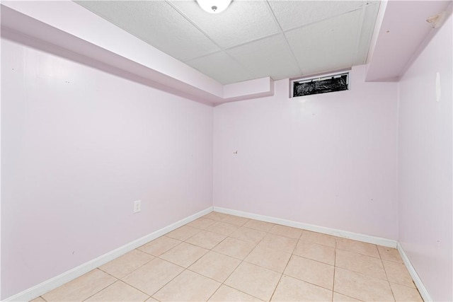 basement featuring a paneled ceiling