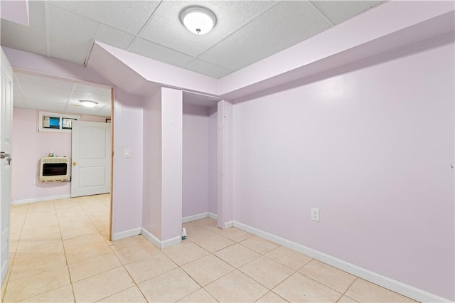 interior space featuring heating unit and a paneled ceiling