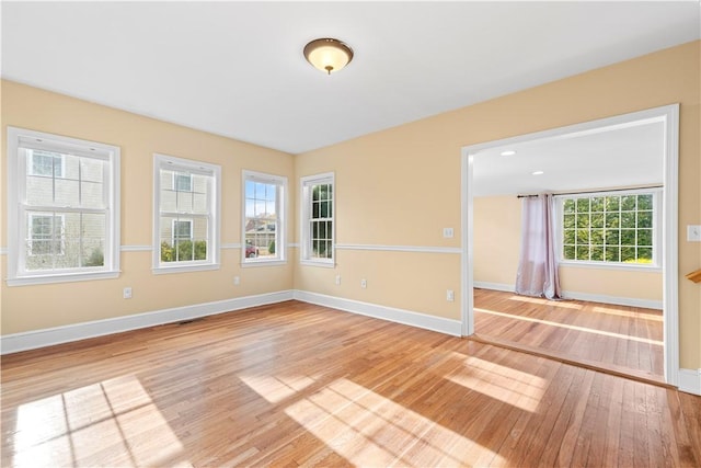 unfurnished room with plenty of natural light and light hardwood / wood-style floors