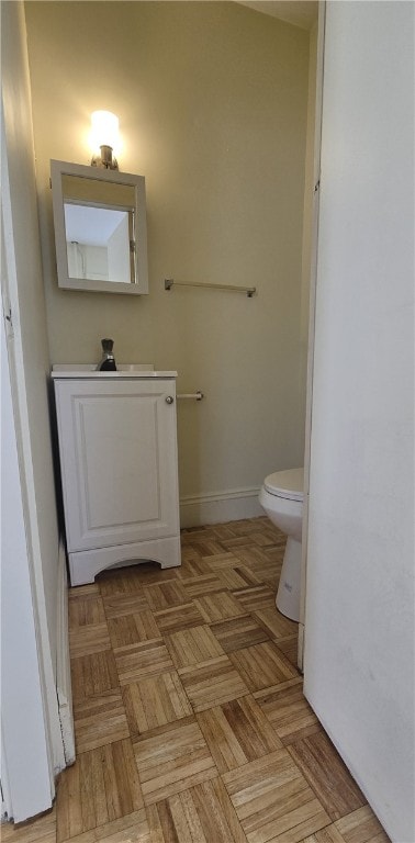 bathroom featuring toilet and parquet floors