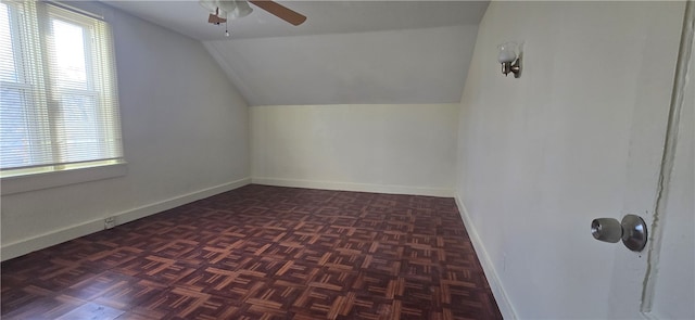 bonus room featuring ceiling fan, dark parquet floors, and vaulted ceiling