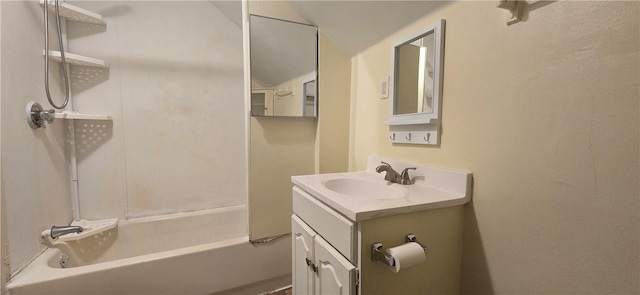 bathroom featuring vaulted ceiling, vanity, and bathtub / shower combination