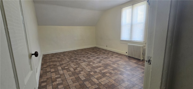 additional living space with lofted ceiling and radiator heating unit