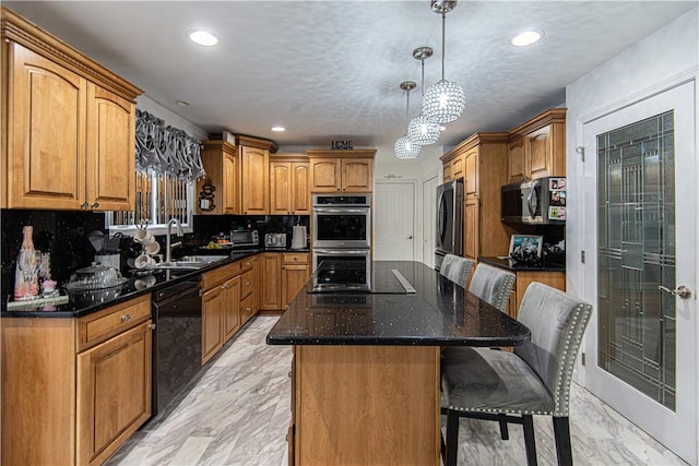 kitchen featuring backsplash, sink, black appliances, decorative light fixtures, and a center island