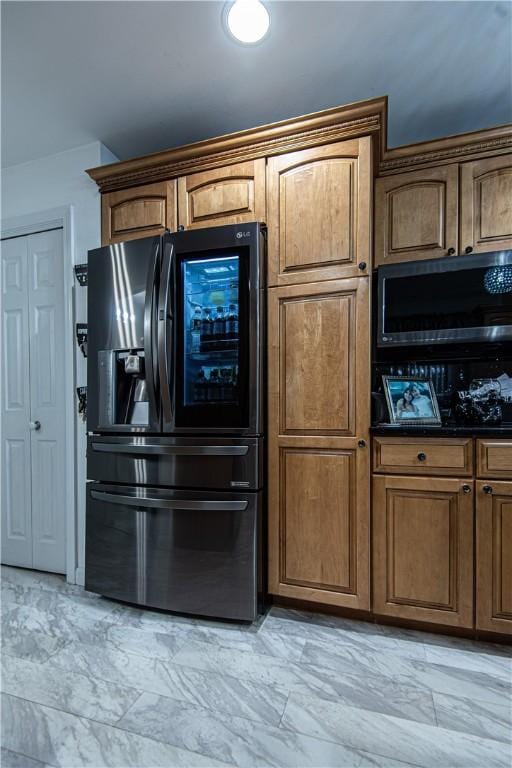 kitchen featuring refrigerator with ice dispenser