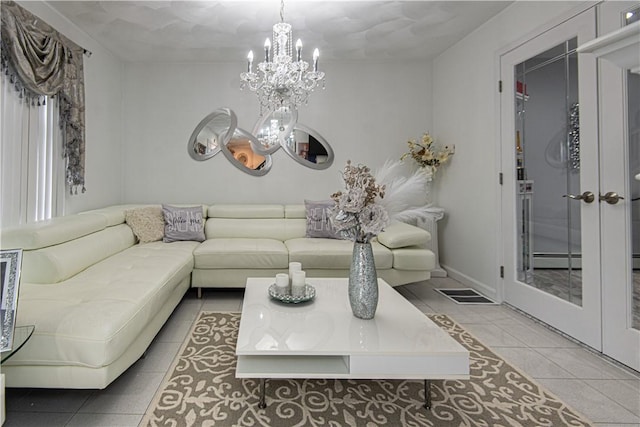 tiled living room featuring a baseboard radiator and an inviting chandelier