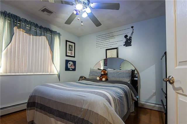 bedroom with baseboard heating, ceiling fan, and dark wood-type flooring