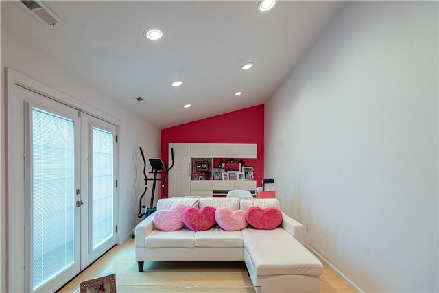 interior space with light hardwood / wood-style floors, lofted ceiling, and french doors