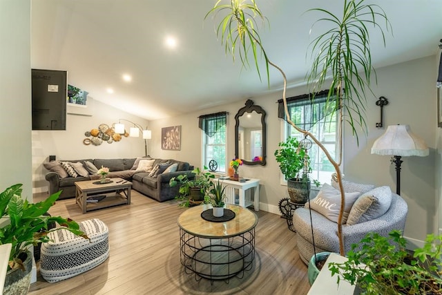 living room with lofted ceiling and light hardwood / wood-style flooring