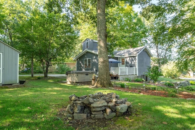 view of yard with a wooden deck and a hot tub