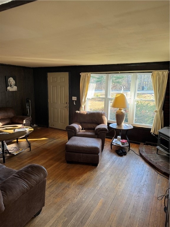 living room featuring hardwood / wood-style flooring and a wood stove