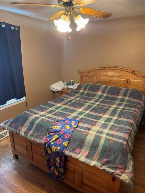 bedroom with ceiling fan and wood-type flooring