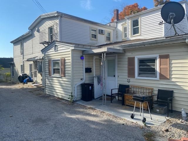 rear view of property featuring a patio area