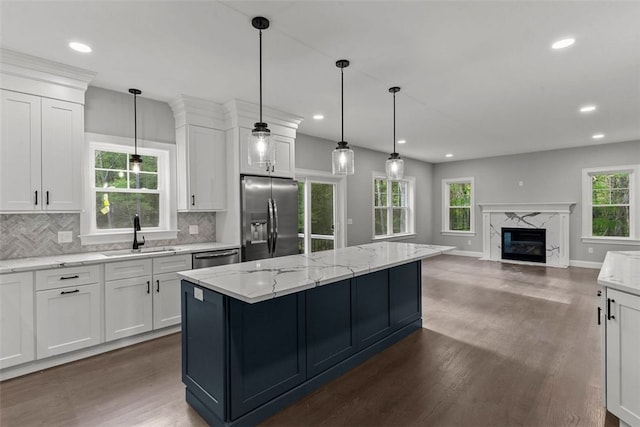 kitchen with dark wood-type flooring, sink, white cabinets, and stainless steel appliances