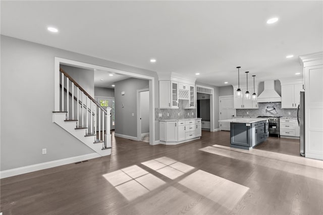 kitchen featuring premium range hood, a center island, and white cabinets