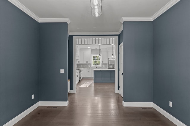 interior space with sink, dark hardwood / wood-style flooring, and crown molding