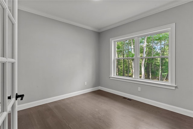 unfurnished room featuring crown molding and dark wood-type flooring