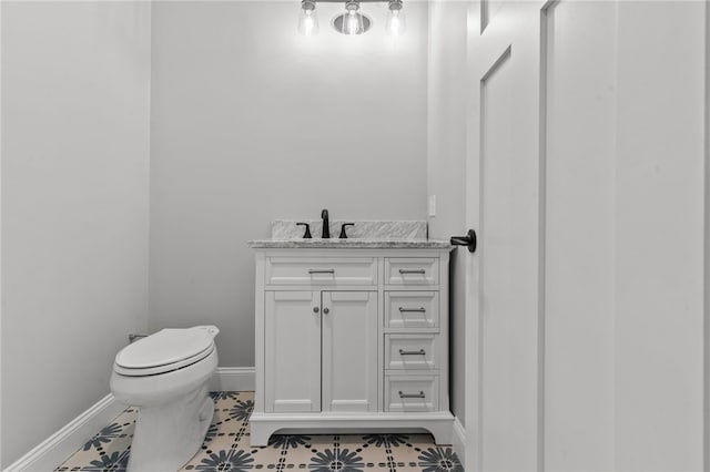 bathroom with tile patterned flooring, vanity, and toilet