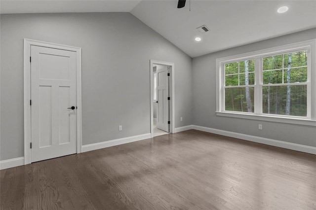 spare room with wood-type flooring, vaulted ceiling, and ceiling fan