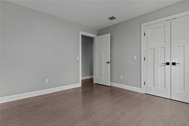 unfurnished bedroom with a closet and light hardwood / wood-style flooring