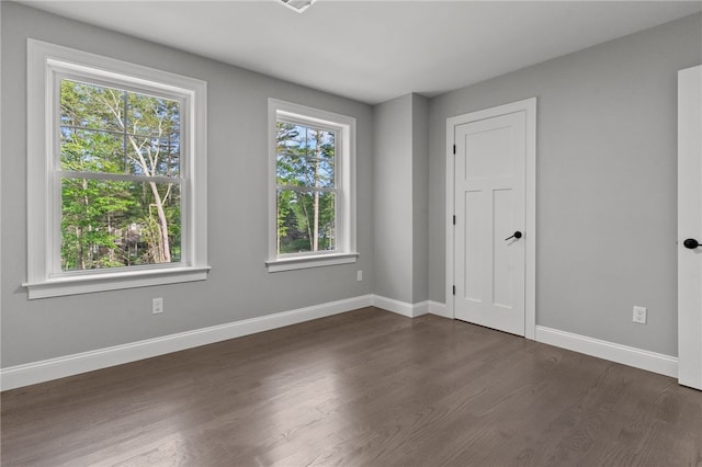 spare room with dark hardwood / wood-style floors