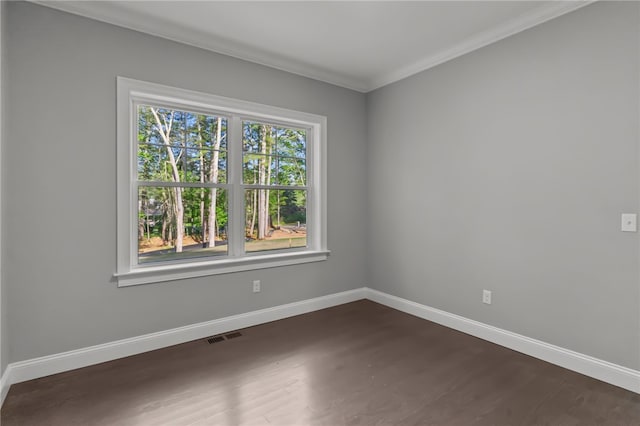 unfurnished room with ornamental molding and dark wood-type flooring