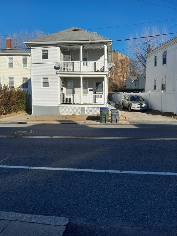 view of front facade with a balcony and covered porch