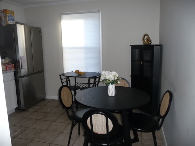 dining room with light tile patterned floors and ornamental molding