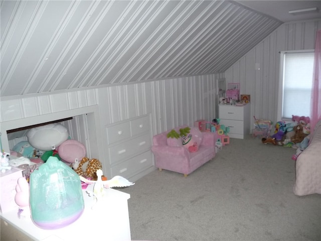 playroom featuring carpet floors and vaulted ceiling