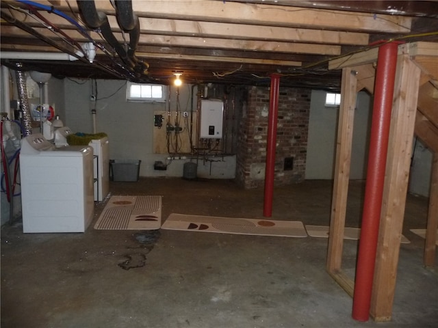 basement featuring water heater and washer and clothes dryer