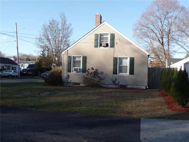 view of home's exterior featuring cooling unit and a lawn